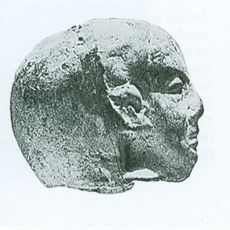 Head from terracotta with features of the Ancient Egyptian statue